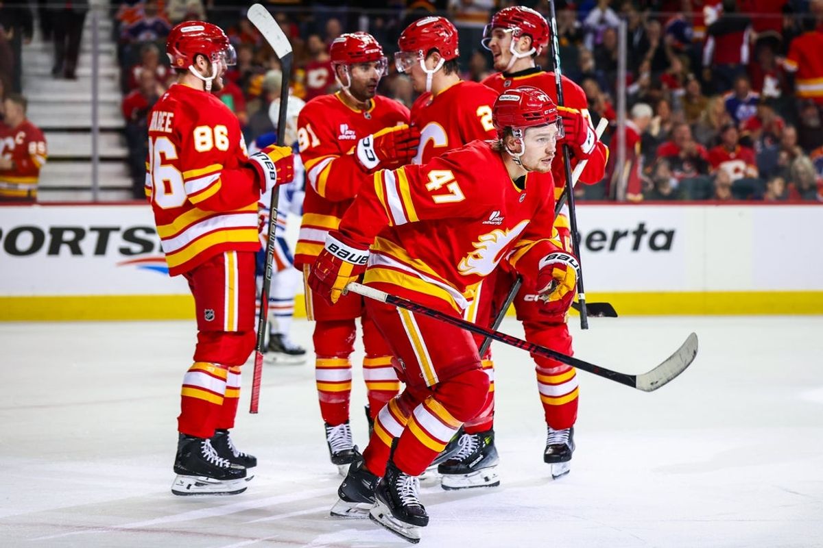 Feb 4, 2026; Calgary, Alberta, CAN; Calgary Flames center Connor Zary (47) celebrates his goal with teammates against the Edmonton Oilers during the second period at Scotiabank Saddledome. Mandatory Credit: Sergei Belski-Imagn Images