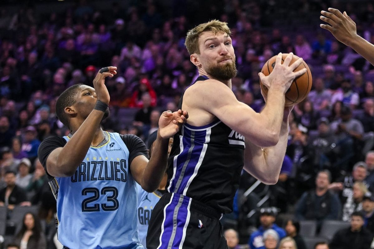 Feb 4, 2026; Sacramento, California, USA; Sacramento Kings forward/center Domantas Sabonis (11) rebounds tagainst Memphis Grizzlies guard Cedric Coward (23) during the third quarter at Golden 1 Center. Mandatory Credit: Ed Szczepanski-Imagn Images