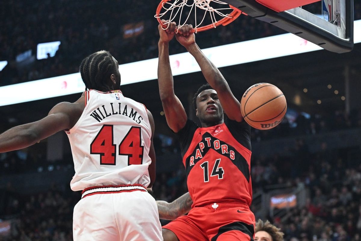 Feb 5, 2026; Toronto, Ontario, CAN; Toronto Raptors guard Ja'Kobe Walter (14) dunks against Chicago Bulls forward Patrick Williams (44) in the first half at Scotiabank Arena. Mandatory Credit: Dan Hamilton-Imagn Images