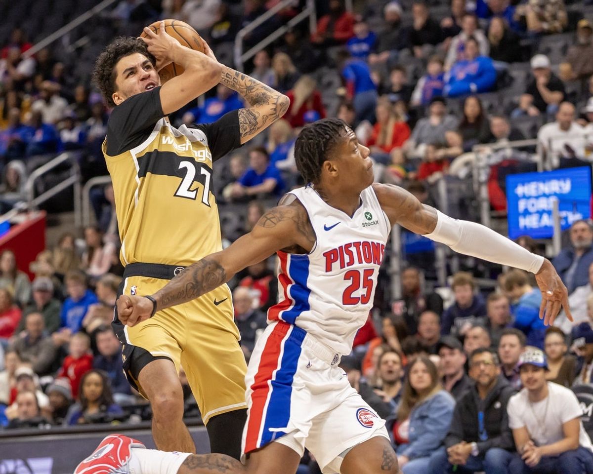 Feb 5, 2026; Detroit, Michigan, USA; Washington Wizards guard Will Riley (27) drives against Detroit Pistons guard Marcus Sasser (25) during the first quarter at Little Caesars Arena. Mandatory Credit: David Reginek-Imagn Images