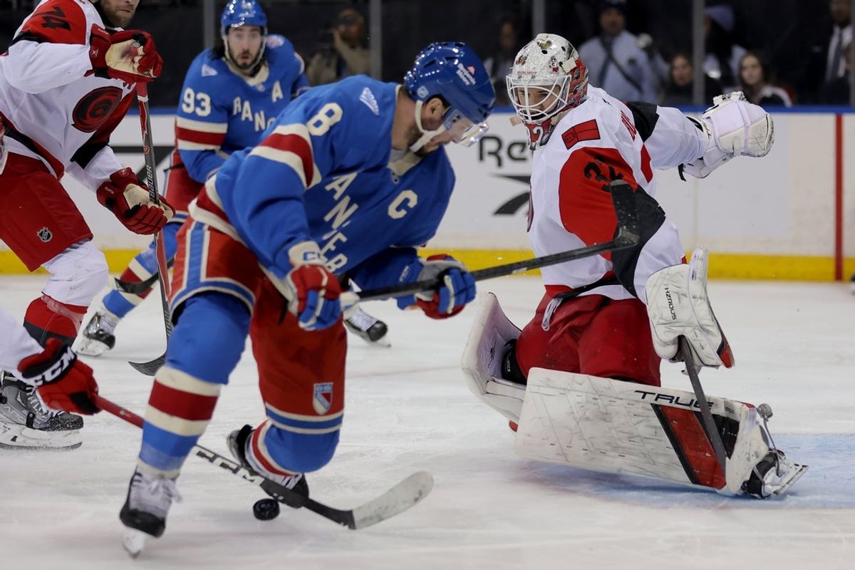 Feb 5, 2026; New York, New York, USA; Carolina Hurricanes goaltender Brandon Bussi (32) makes a save against New York Rangers left wing J.T. Miller (8) during the second period at Madison Square Garden. Mandatory Credit: Brad Penner-Imagn Images