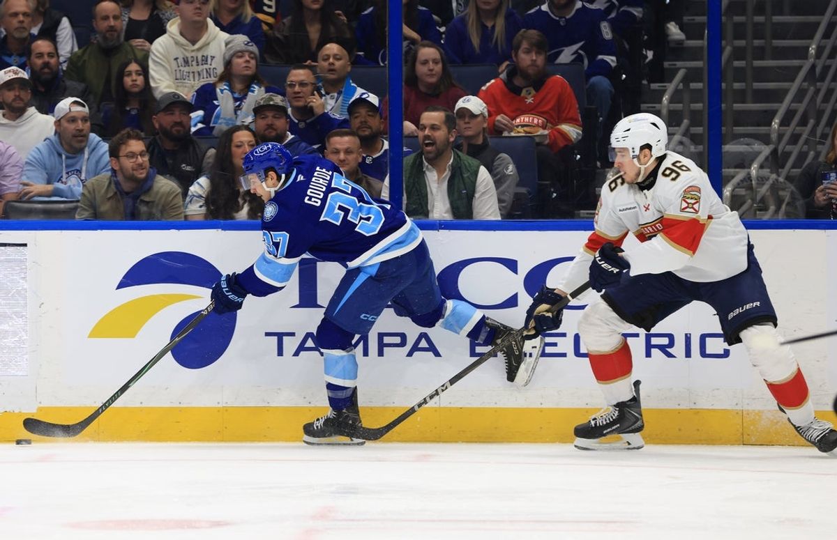 Feb 5, 2026; Tampa, Florida, USA; Tampa Bay Lightning center Yanni Gourde (37) passes against Florida Panthers defenseman Mikulas Hovorka (96) during the first period at Benchmark International Arena. Mandatory Credit: Kim Klement Neitzel-Imagn Images