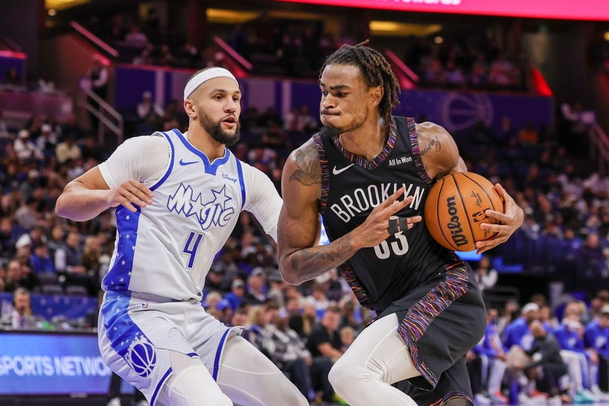 Feb 5, 2026; Orlando, Florida, USA; Brooklyn Nets center Nic Claxton (33) drives against Orlando Magic guard Jalen Suggs (4) during the second quarter at Kia Center. Mandatory Credit: Mike Watters-Imagn Images