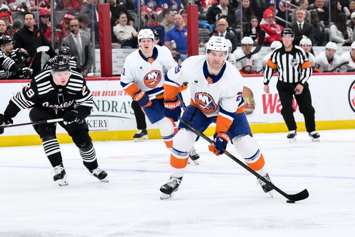 Feb 5, 2026; Newark, New Jersey, USA; New York Islanders left wing Jonathan Drouin (29) skates past New Jersey Devils right wing Lenni Hameenaho (29) pursues during the third period at Prudential Center. Mandatory Credit: John Jones-Imagn Images