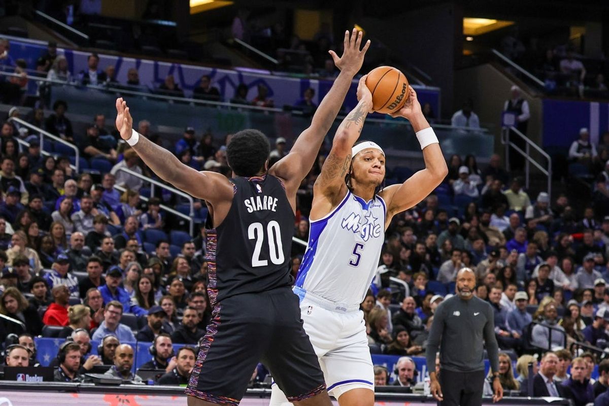 Feb 5, 2026; Orlando, Florida, USA; Orlando Magic forward Paolo Banchero (5) passes against Brooklyn Nets center Day'ron Sharpe (20) during the second half at Kia Center. Mandatory Credit: Mike Watters-Imagn Images