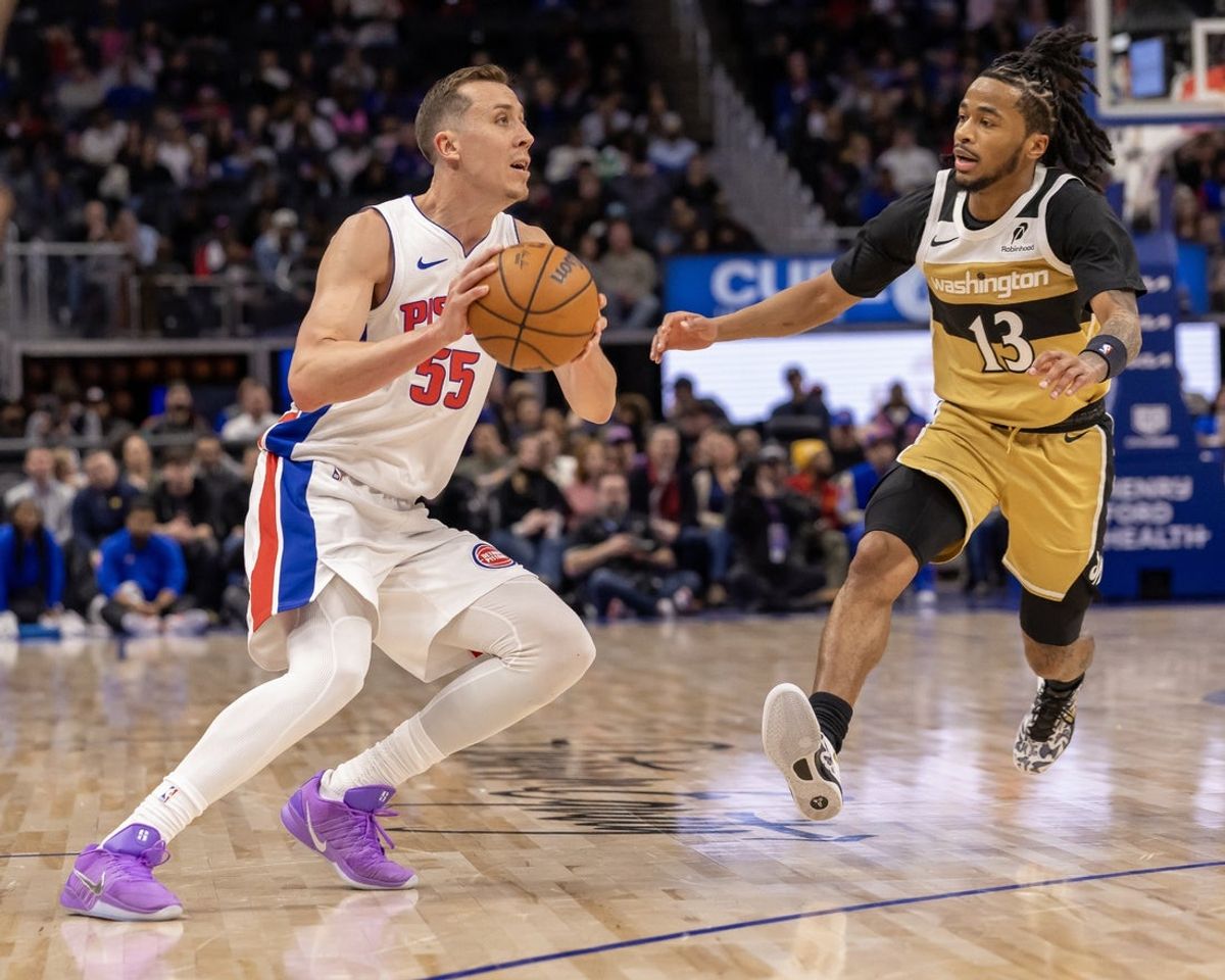 Feb 5, 2026; Detroit, Michigan, USA; Detroit Pistons forward Duncan Robinson (55) prepares to shoot against Washington Wizards guard Sharife Cooper (13) during the second half at Little Caesars Arena. Mandatory Credit: David Reginek-Imagn Images