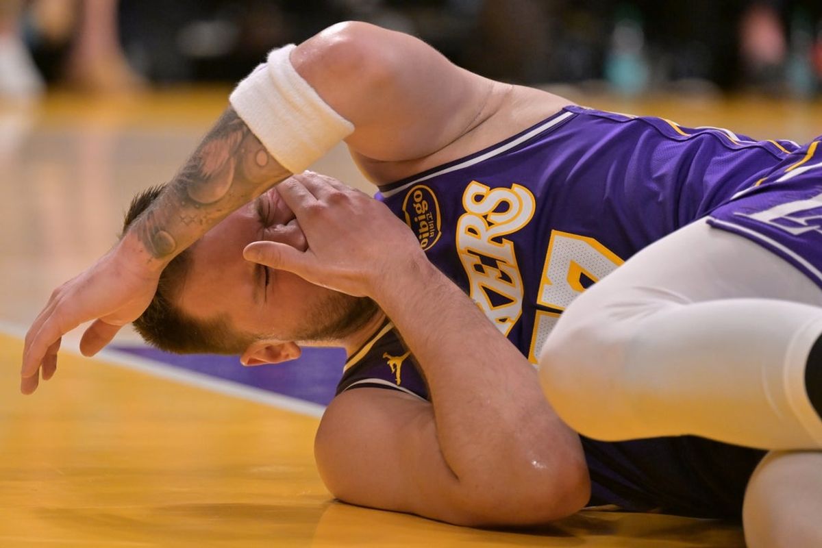 Feb 5, 2026; Los Angeles, California, USA;  Los Angeles Lakers guard Luka Doncic (77) reacts after he was hit in the face defending a shot in the first half against the Philadelphia 76ers at Crypto.com Arena. Mandatory Credit: Jayne Kamin-Oncea-Imagn Images