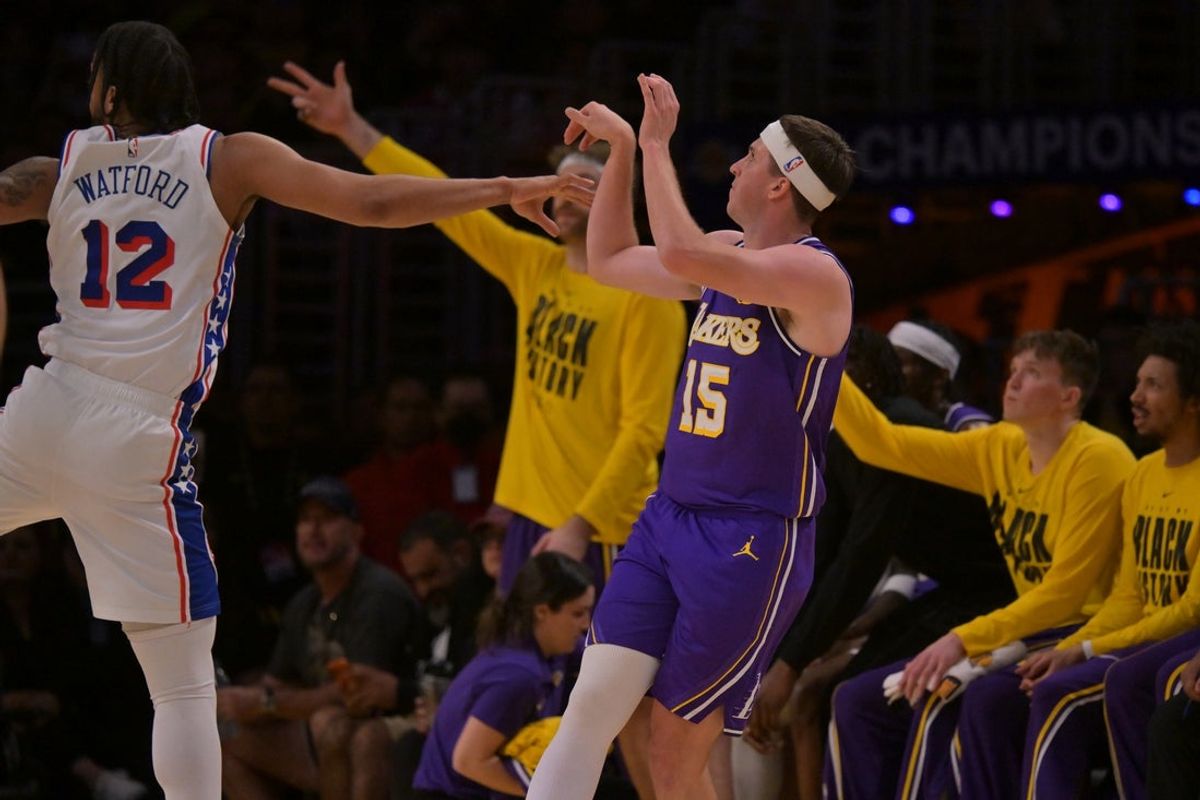 Feb 5, 2026; Los Angeles, California, USA;  Los Angeles Lakers guard Austin Reaves (15) hits a three-point basket in the first half against the Philadelphia 76ers at Crypto.com Arena. Mandatory Credit: Jayne Kamin-Oncea-Imagn Images