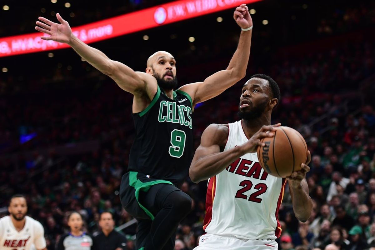 Feb 6, 2026; Boston, Massachusetts, USA;  Miami Heat forward Andrew Wiggins (22) drives to the basket past Boston Celtics guard Derrick White (9) during the first half at TD Garden. Mandatory Credit: Bob DeChiara-Imagn Images