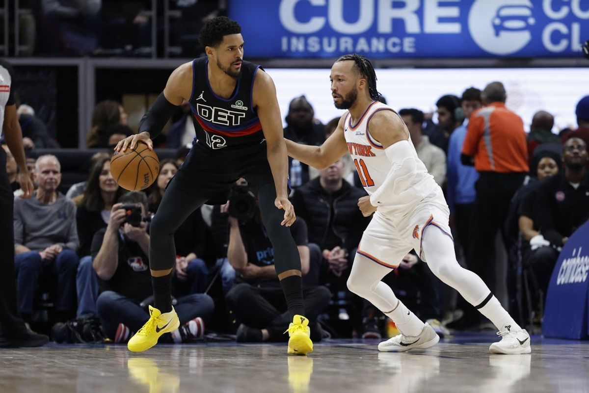 Feb 6, 2026; Detroit, Michigan, USA;  Detroit Pistons forward Tobias Harris (12) is defended by New York Knicks guard Jalen Brunson (11) in the first half at Little Caesars Arena. Mandatory Credit: Rick Osentoski-Imagn Images