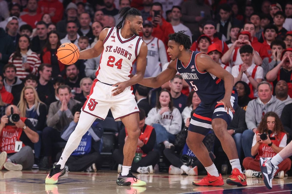Feb 6, 2026; New York, New York, USA;  St. John's Red Storm forward Zuby Ejiofor (24) looks to drive past UConn Huskies forward Tarris Reed Jr. (5) in the first half at Madison Square Garden. Mandatory Credit: Wendell Cruz-Imagn Images
