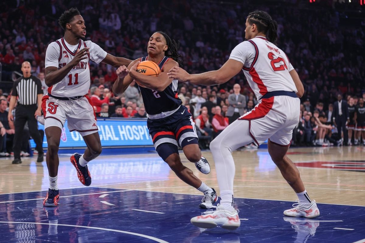 Feb 6, 2026; New York, New York, USA;  UConn Huskies guard Silas Demary Jr. (2) drives past  St. John's Red Storm guard Ian Jackson (11) and forward Bryce Hopkins (23) in the first half at Madison Square Garden. Mandatory Credit: Wendell Cruz-Imagn Images