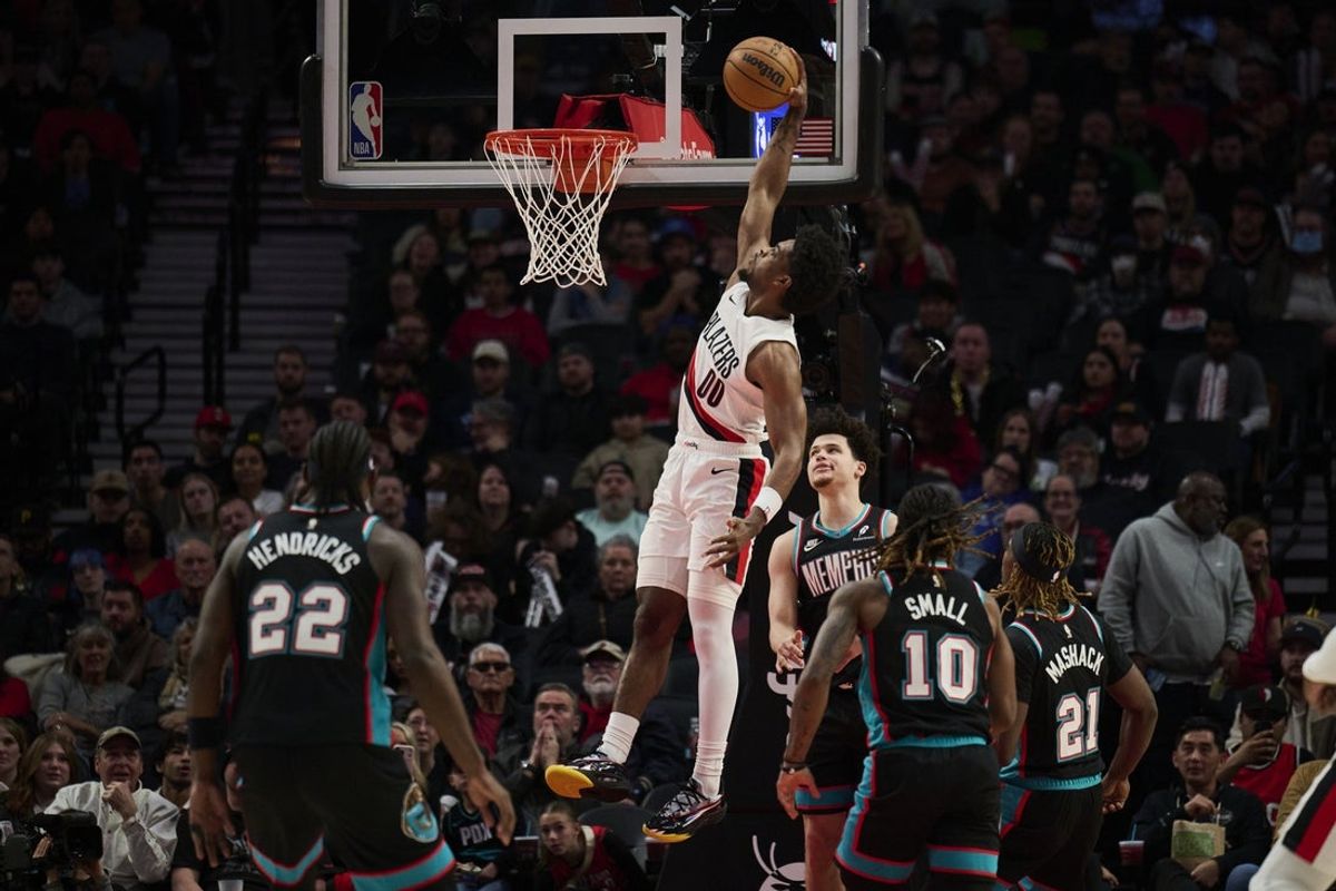 Feb 6, 2026; Portland, Oregon, USA; Portland Trail Blazers guard Scoot Henderson (00) dunks the basketball during the second half against Memphis Grizzlies guard Walter Clayton Jr. (4) at Moda Center. Mandatory Credit: Troy Wayrynen-Imagn Images