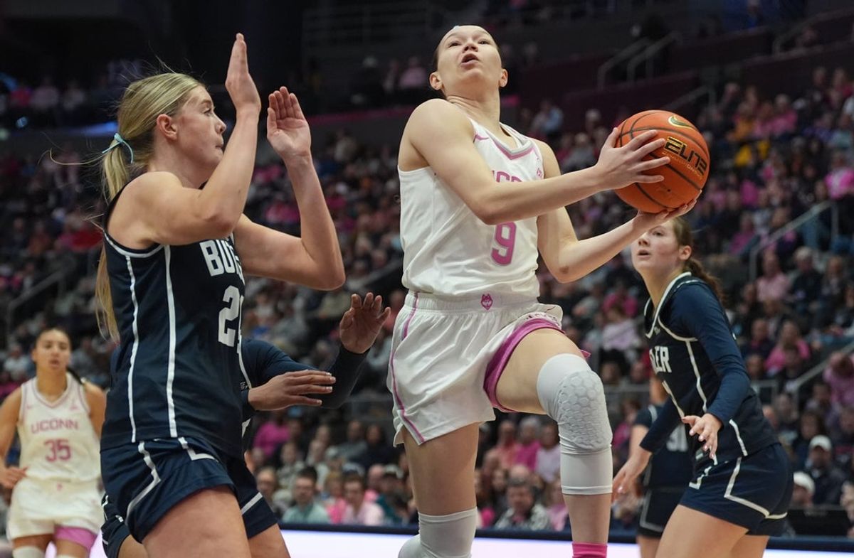 Feb 7, 2026; Hartford, Connecticut, USA; UConn Huskies guard Kayleigh Heckel (9) drives the ball to the basket against Butler Bulldogs forward Mallory Miller (24) in the first half at PeoplesBank Arena. Mandatory Credit: David Butler II-Imagn Images
