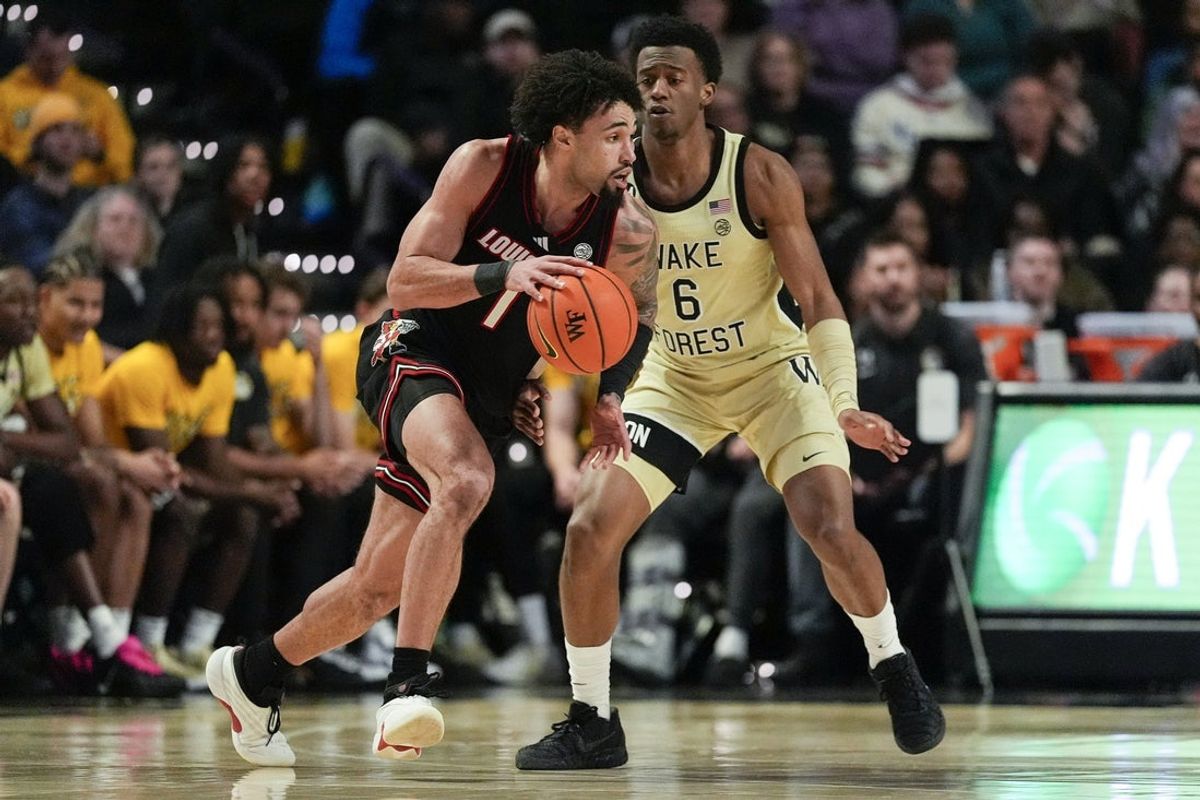 Feb 7, 2026; Winston-Salem, North Carolina, USA; Louisville Cardinals guard J'vonne Hadley (1) drives to the basket against Wake Forest Demon Deacons guard Myles Colvin (6) during the first half at Lawrence Joel Veterans Memorial Coliseum. Mandatory Credit: Jim Dedmon-Imagn Images