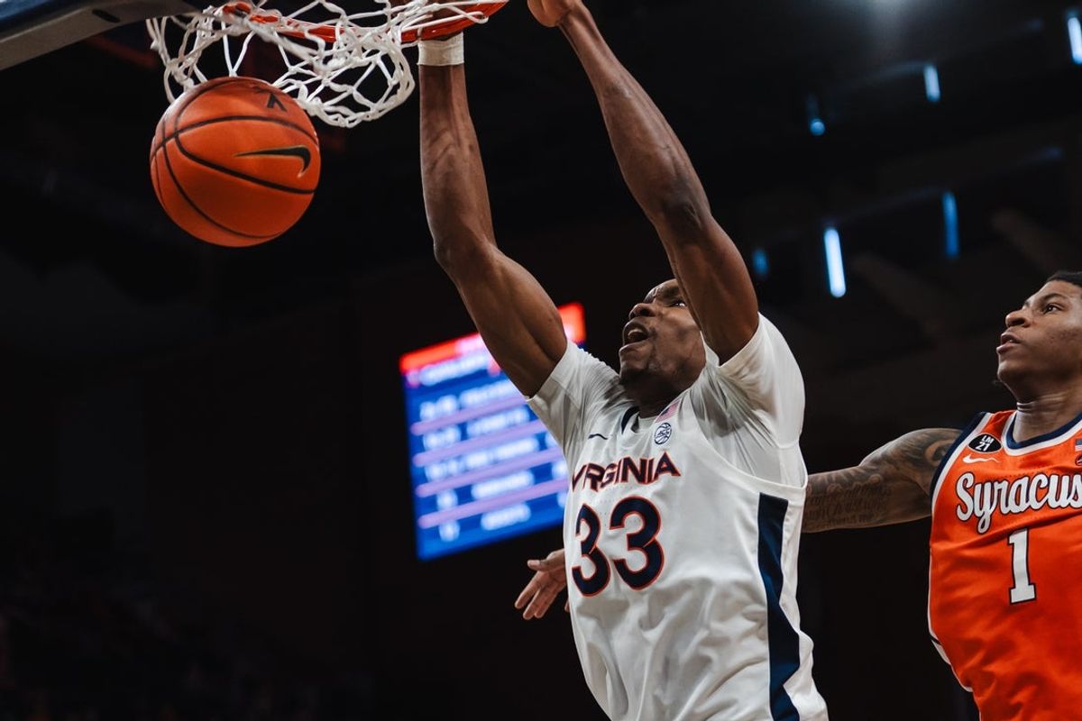 Feb 7, 2026; Charlottesville, Virginia, USA; Virginia Cavaliers center Ugonna Onyenso (33) dunks the ball while Syracuse Orange forward Donnie Freeman (1) defends during the second half at John Paul Jones Arena. Mandatory Credit: Emily Faith Morgan-Imagn Images