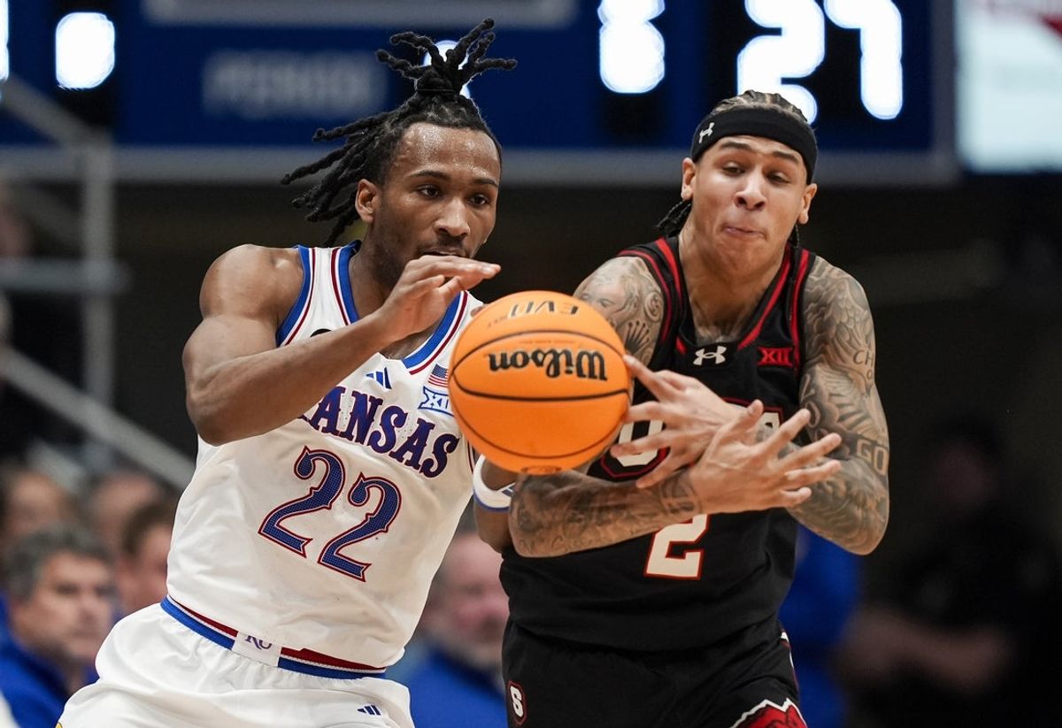 Feb 7, 2026; Lawrence, Kansas, USA; Utah Utes guard Terrence Brown (2) steals the ball from Kansas Jayhawks guard Darryn Peterson (22) during the first half at Allen Fieldhouse. Mandatory Credit: Jay Biggerstaff-Imagn Images
