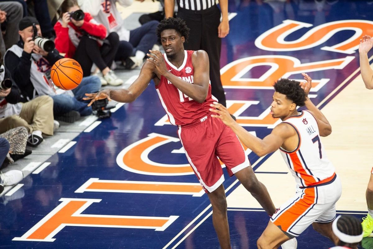 Alabama Crimson Tide center Charles Bediako (14) passes the ball as Auburn Tigers take on Alabama Crimson Tide at Neville Arena in Auburn, Ala. on Saturday, Feb. 7, 2026. Auburn Tigers lead Alabama Crimson Tide 41-37 at halftime.