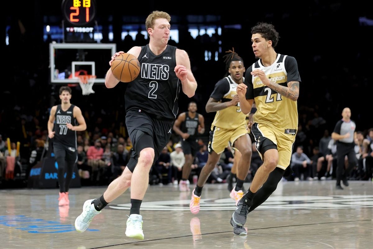 Feb 7, 2026; Brooklyn, New York, USA; Brooklyn Nets forward Danny Wolf (2) drives to the basket against Washington Wizards guard Will Riley (27) during the fourth quarter at Barclays Center. Mandatory Credit: Brad Penner-Imagn Images