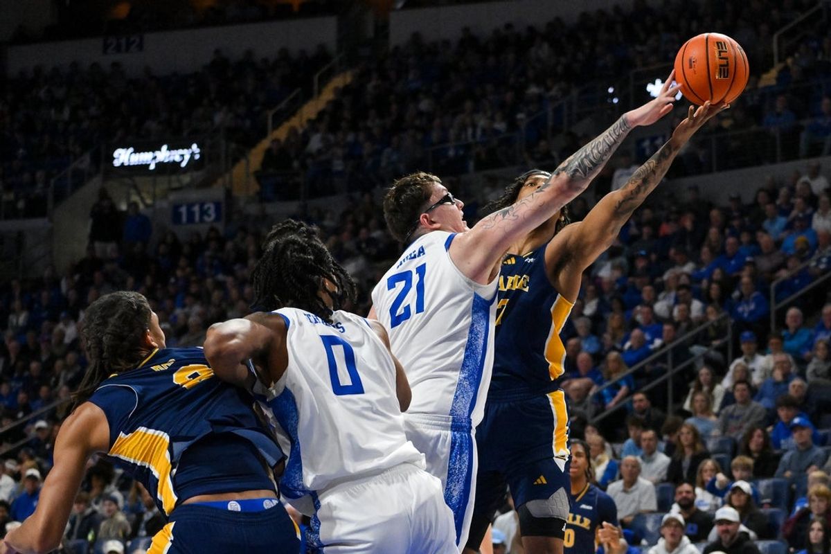 Feb 7, 2026; St. Louis, Missouri, USA;  Saint Louis Billikens center Robbie Avila (21) blocks a shot attempt by La Salle Explorers forward Edwin Daniel (27) during the second half at Chaifetz Arena. Mandatory Credit: Jeff Curry-Imagn Images