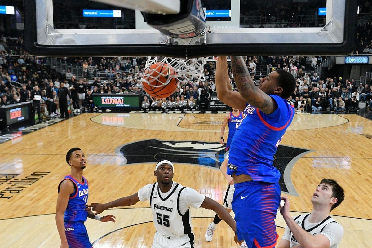 Feb 7, 2026; Providence, Rhode Island, USA; DePaul Blue Demons forward N.J. Benson (35) hangs from the rim after dunking the ball against the Providence Friars during the second half at Amica Mutual Pavilion. Mandatory Credit: Eric Canha-Imagn Images
