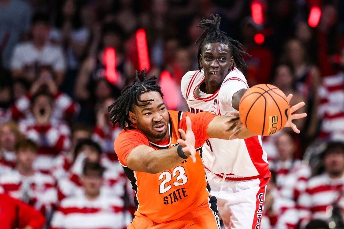 Feb 7, 2026; Tucson, Arizona, USA; Oklahoma State Cowboys center Benjamin Ahmed (23) and Arizona Wildcats forward Sidi Gueye (15) both reach to catch the ball during the second half of the game at McKale Memorial Center. Mandatory Credit: Aryanna Frank-Imagn Images