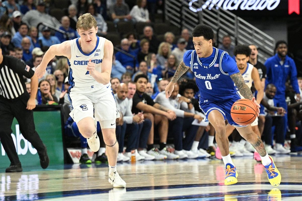 Feb 7, 2026; Omaha, Nebraska, USA; Seton Hall Pirates guard Adam Clark (0) drives up the court against Creighton Bluejays guard Josh Dix (4) during the first half at CHI Health Center Omaha. Mandatory Credit: Steven Branscombe-Imagn Images