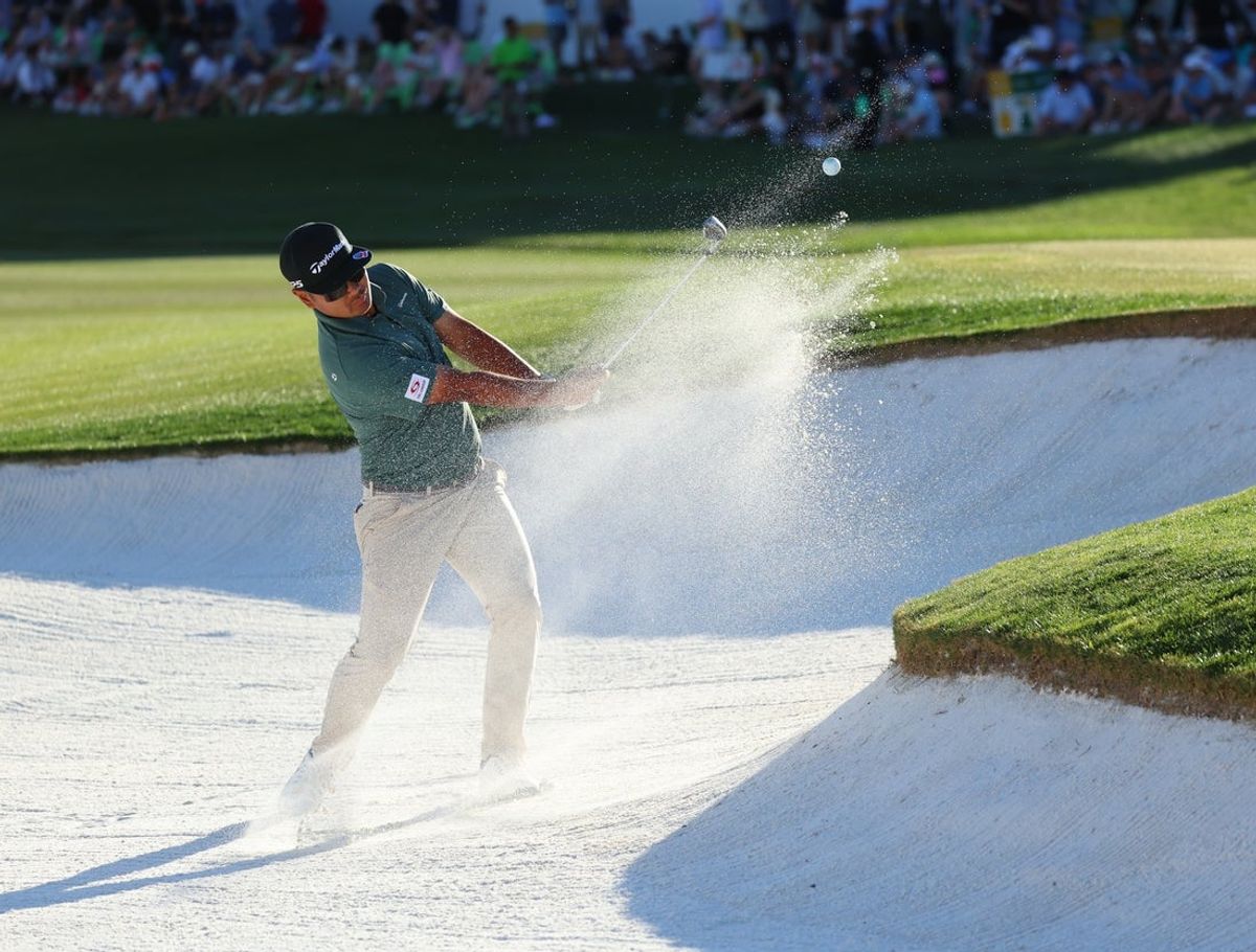 Feb 7, 2026; Scottsdale, Arizona, USA; Hideki Matsuyama of the Republic of Korea hits a shot out of the bunker on hole 18 during the third round of the WM Phoenix Open golf tournament. Mandatory Credit: Anna Carrington-Imagn Images