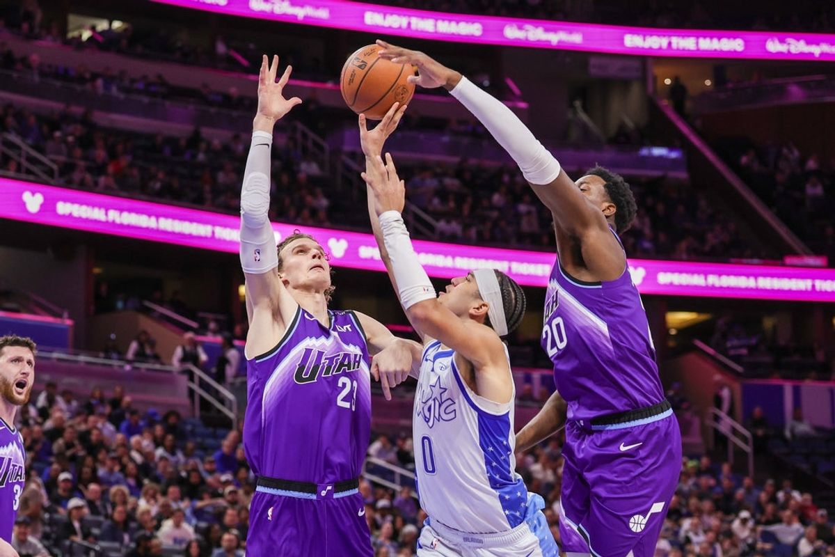 Feb 7, 2026; Orlando, Florida, USA; Orlando Magic guard Anthony Black (0) is fouled by Utah Jazz forward Lauri Markkanen (23) during the first quarter at Kia Center. Mandatory Credit: Mike Watters-Imagn Images