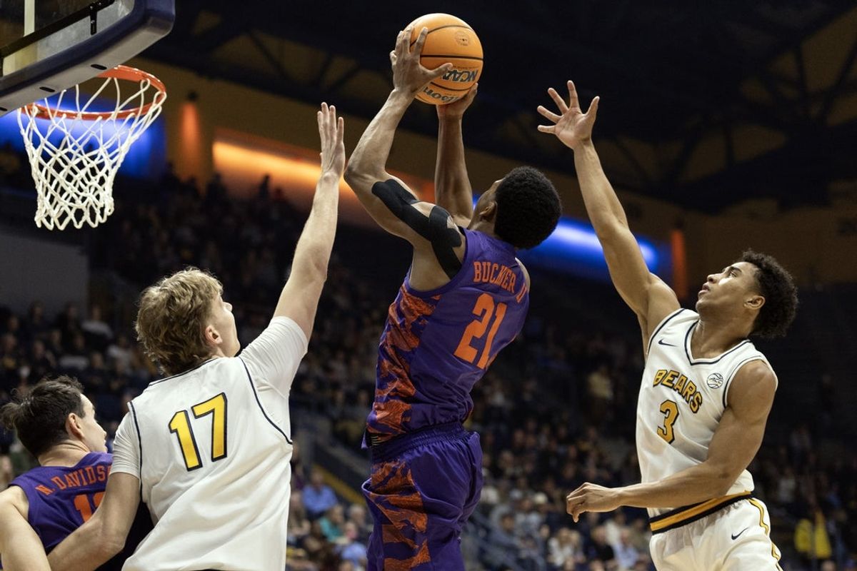 Feb 7, 2026; Berkeley, California, USA; Clemson Tigers guard Ace Buckner (21) lays the ball up between California Golden Bears defenders Mantas Kocanas (17) and Semetri (TT) Carr (3) during the first half at Haas Pavilion. Mandatory Credit: D. Ross Cameron-Imagn Images