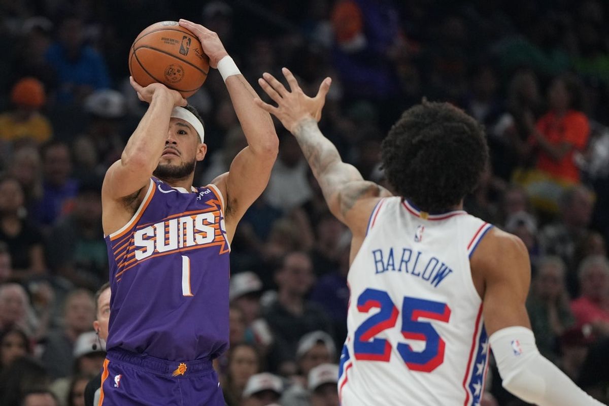 Feb 7, 2026; Phoenix, Arizona, USA; Phoenix Suns guard Devin Booker (1) shoots over Philadelphia 76ers forward Dominick Barlow (25) during the first half of an NBA game at Mortgage Matchup Center. Mandatory Credit: Rick Scuteri-Imagn Images