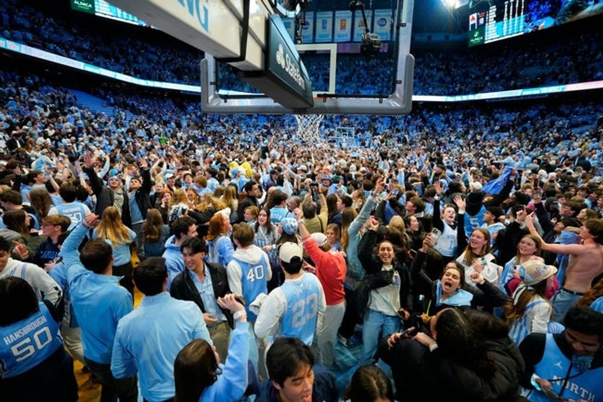 Feb 7, 2026; Chapel Hill, North Carolina, USA; North Carolina Tar Heels students storm the court after the game at Dean E. Smith Center. Mandatory Credit: Bob Donnan-Imagn Images
