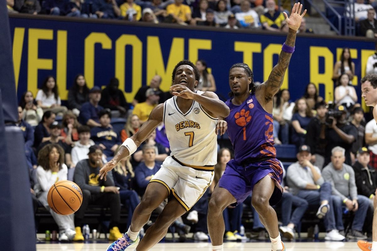 Feb 7, 2026; Berkeley, California, USA; California Golden Bears guard Dai Dai Ames (7) loses control of his dribble as he tries to drive around Clemson Tigers guard Jestin Porter (1) during the second half at Haas Pavilion. Mandatory Credit: D. Ross Cameron-Imagn Images