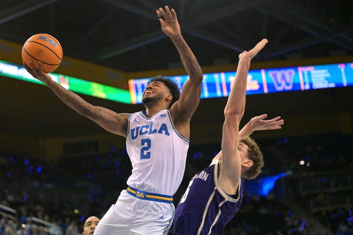 Feb 7, 2026; Los Angeles, California, USA;  UCLA Bruins guard Trent Perry (0) is defended by Washington Huskies forward Hannes Steinbach (6) as he drives to the basket in the first half at Pauley Pavilion presented by Wescom Financial. Mandatory Credit: Jayne Kamin-Oncea-Imagn Images