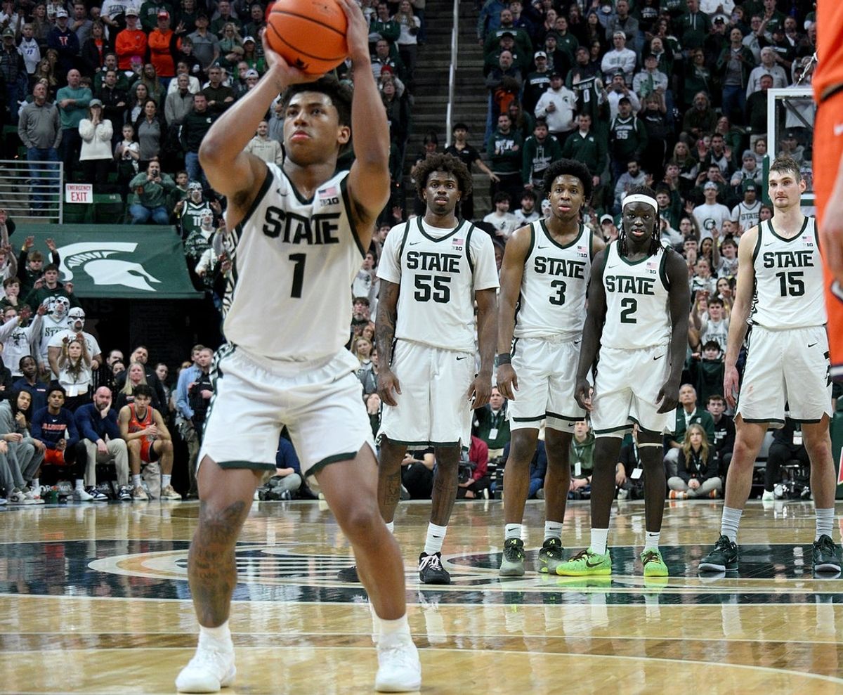 Feb 7, 2026; East Lansing, Michigan, USA;  Michigan State Spartans guard Jeremy Fears Jr. (1) shoots free throws in overtime while his teammates watch in their game against the Illinois Fighting Illini at Jack Breslin Student Events Center. Mandatory Credit: Dale Young-Imagn Images