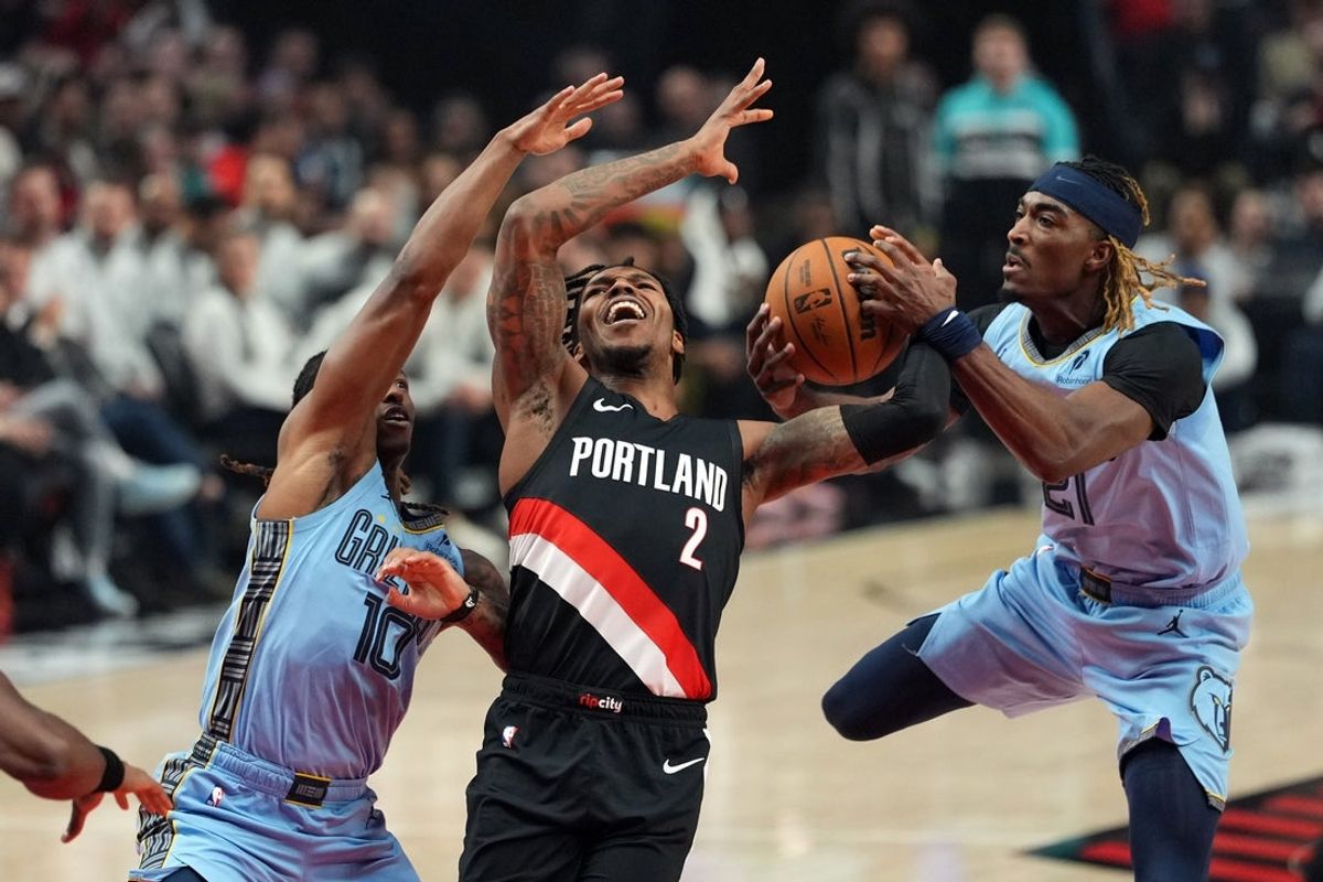 Feb 7, 2026; Portland, Oregon, USA; Memphis Grizzlies guard Jahmai Mashack (21) strips the ball from Portland Trail Blazers guard Caleb Love (2) during the first half at Moda Center. Mandatory Credit: Soobum Im-Imagn Images