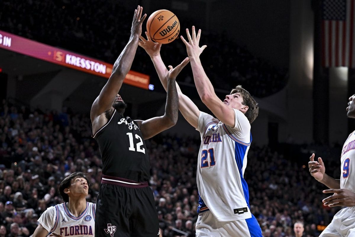 Feb 7, 2026; College Station, Texas, USA; Florida Gators forward Alex Condon (21) and Texas A&M Aggies forward Rashaun Agee (12) go for the rebound during the second half at Reed Arena. Mandatory Credit: Maria Lysaker-Imagn Images