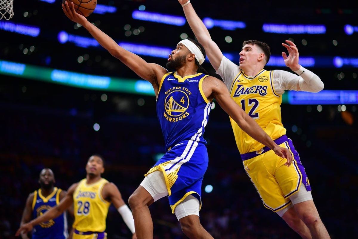 Feb 7, 2026; Los Angeles, California, USA; Golden State Warriors guard Moses Moody (4) shoots ahead of Los Angeles Lakers forward Jake LaRavia (12) during the second half at Crypto.com Arena. Mandatory Credit: Gary A. Vasquez-Imagn Images