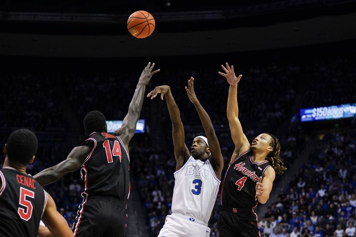 Feb 7, 2026; Provo, Utah, USA; BYU Cougars forward AJ Dybantsa (3) shoots the ball against Houston Cougars forward Kalifa Sakho (14) guard Kingston Flemings (4) during the first half at Marriott Center. Mandatory Credit: Aaron Baker-Imagn Images
