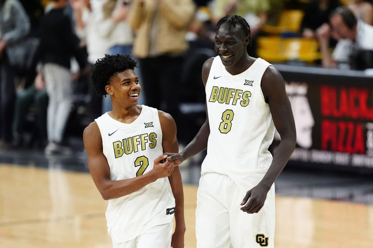 Feb 7, 2026; Boulder, Colorado, USA; Colorado Buffaloes guard Isaiah Johnson (2) and forward Bangot Dak (8) celebrate defeating the Arizona State Sun Devils at the CU Events Center. Mandatory Credit: Ron Chenoy-Imagn Images