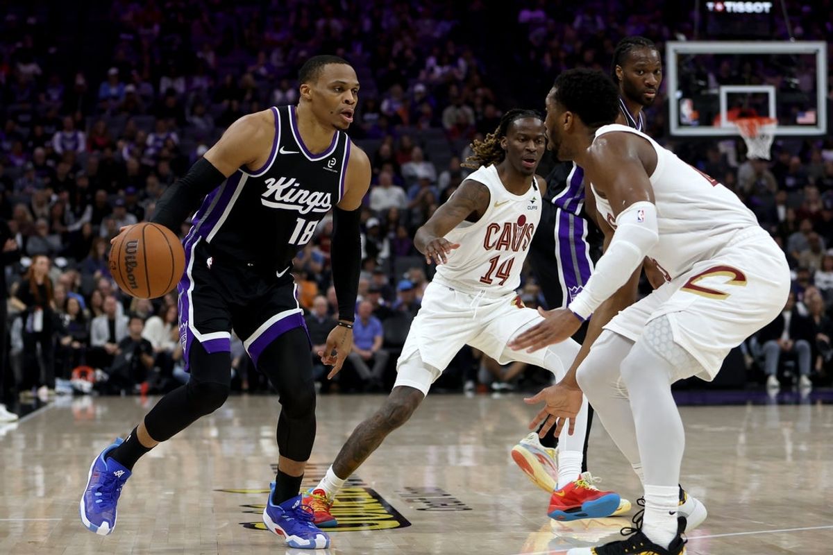 Feb 7, 2026; Sacramento, California, USA; Sacramento Kings guard Russel Westbrook (18) controls the ball while being defended by Cleveland Cavaliers guard Donovan Mitchell (45) during the second quarter at Golden 1 Center. Mandatory Credit: Dennis Lee-Imagn Images