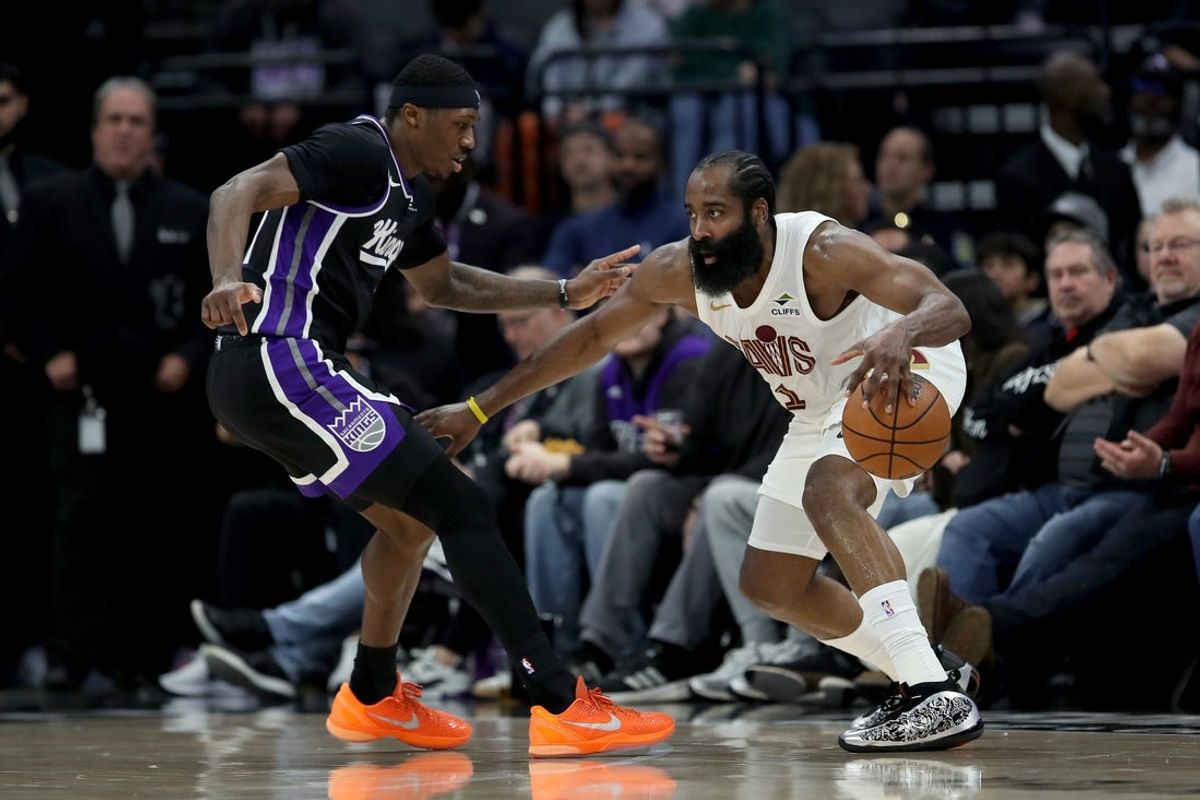 Feb 7, 2026; Sacramento, California, USA; Cleveland Cavaliers guard James Harden (1) controls the ball while being defended by Sacramento Kings guard-forward Daeqwon Plowden (29) during the second quarter at Golden 1 Center. Mandatory Credit: Dennis Lee-Imagn Images