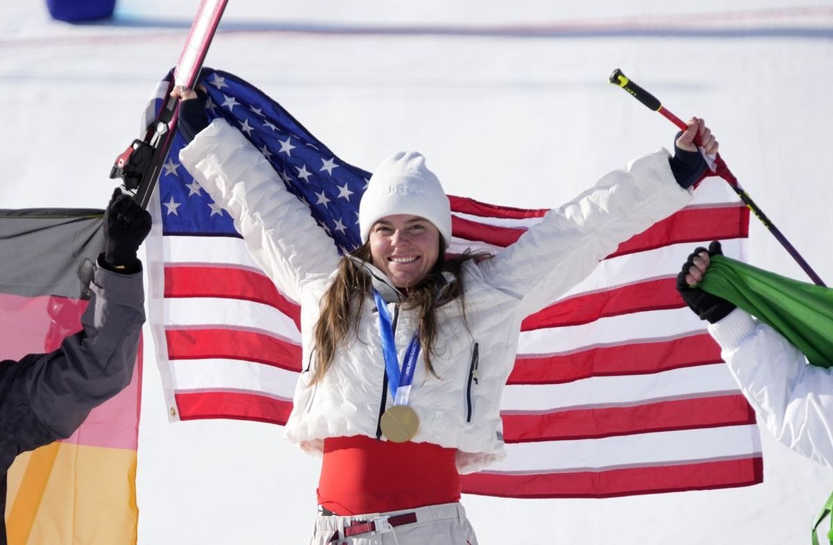 Feb 8, 2026; Cortina d'Ampezzo, Italy; Breezy Johnson of the United States celebrates with her gold medal after winning the women's downhill alpine skiing race during the Milano Cortina 2026 Olympic Winter Games at Tofane Alpine Skiing Centre. Mandatory Credit: Michael Madrid-Imagn Images