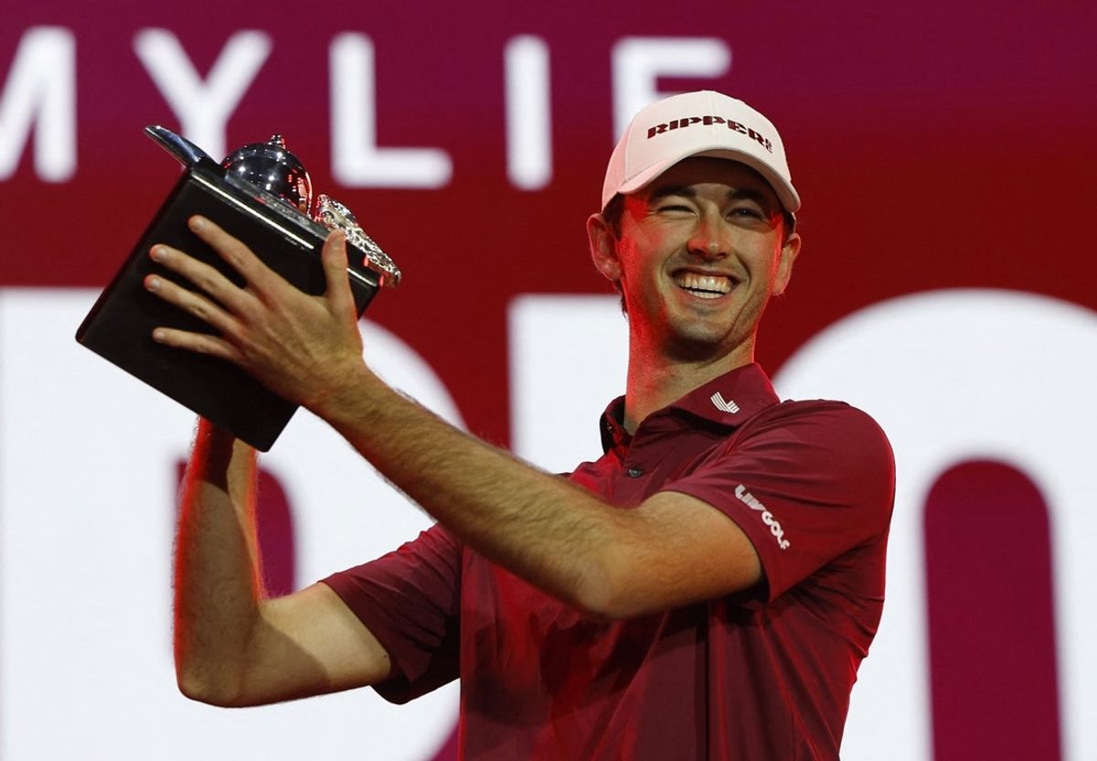Feb 7, 2026; Riyadh, SAUDI ARABIA;  Elvis Smylie celebrates with the trophy after winning during the final round of play at LIV Golf Riyadh at the Riyadh Golf Club. Mandatory Credit: Hamad I Mohammed/Reuters via Imagn Images