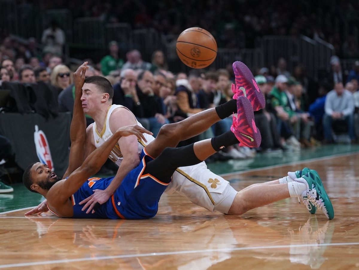 Feb 8, 2026; Boston, Massachusetts, USA; New York Knicks guard Mikal Bridges (25) passes the ball against Boston Celtics guard Payton Pritchard (11) in the first quarter at TD Garden. Mandatory Credit: David Butler II-Imagn Images