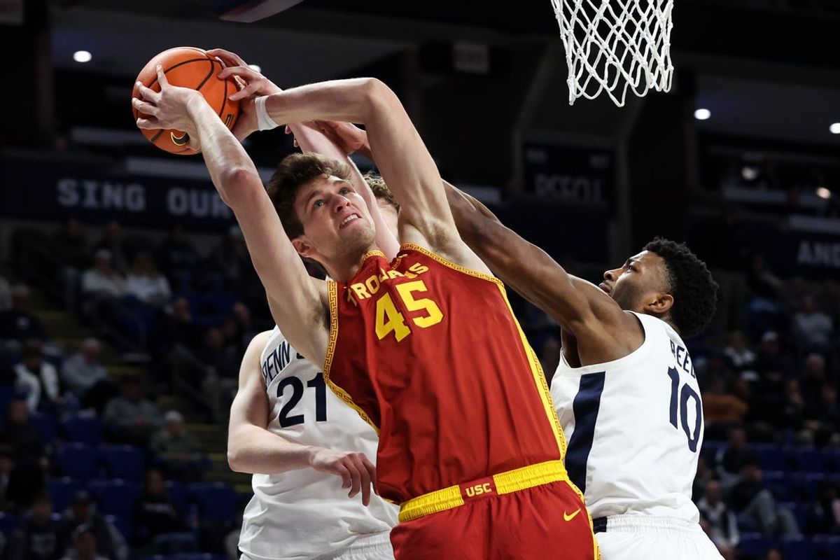 Feb 8, 2026; University Park, Pennsylvania, USA; Southern California Trojans center Gabe Dynes (45) and Penn State Nittany Lions forward Josh Reed (10) fight for the ball during the second half at Bryce Jordan Center. Mandatory Credit: Matthew O'Haren-Imagn Images