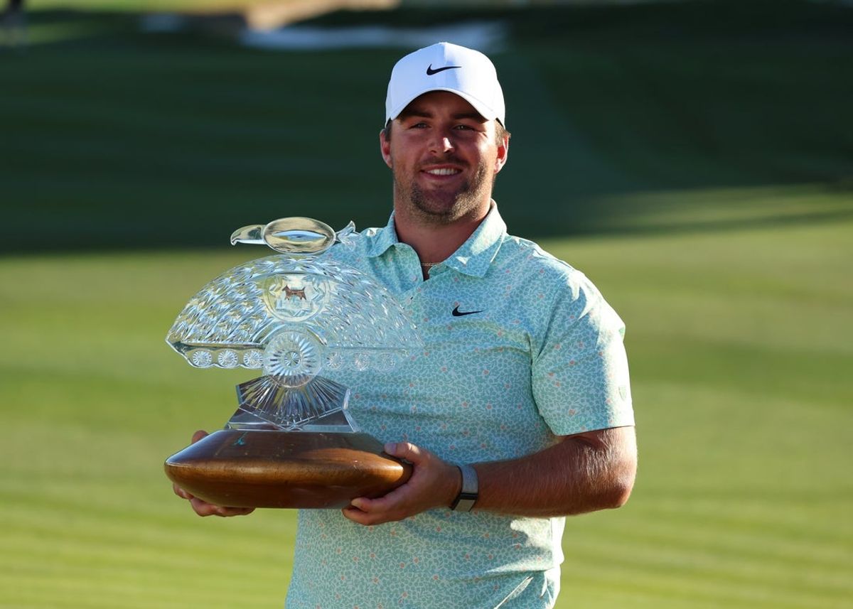 Feb 8, 2026; Scottsdale, Arizona, USA; Chris Gotterup of the United States celebrates his win with the trophy after the final round of the WM Phoenix Open golf tournament. Mandatory Credit: Anna Carrington-Imagn Images