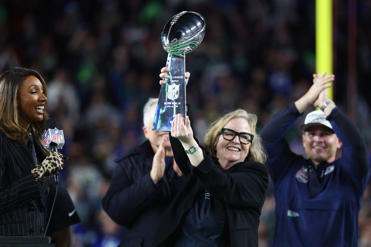 Feb 8, 2026; Santa Clara, CA, USA; Seattle Seahawks chairman Jody Allen celebrates with the Vince Lombardi trophy on the podium after defeating the New England Patriots in Super Bowl LX at Levi's Stadium. Mandatory Credit: Mark J. Rebilas-Imagn Images