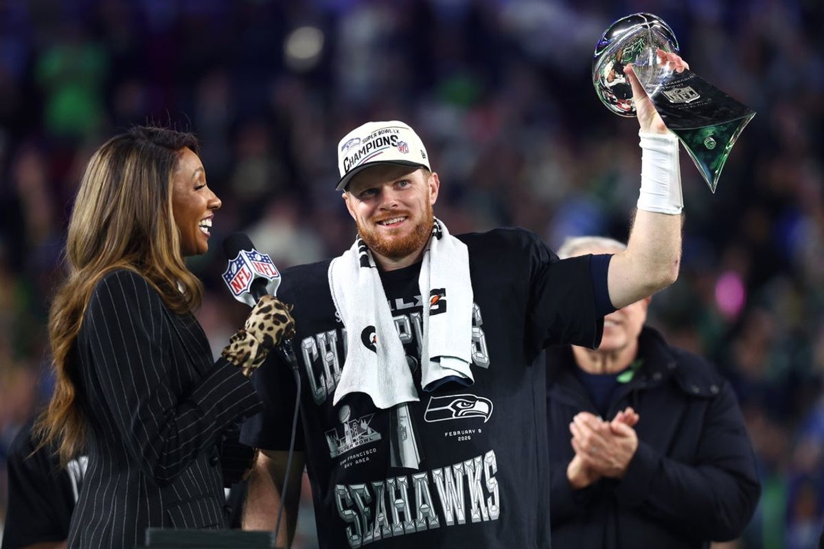 Feb 8, 2026; Santa Clara, CA, USA; Seattle Seahawks quarterback Sam Darnold (14) celebrates with the Vince Lombardi trophy on the podium after defeating the New England Patriots in Super Bowl LX at Levi's Stadium. Mandatory Credit: Mark J. Rebilas-Imagn Images