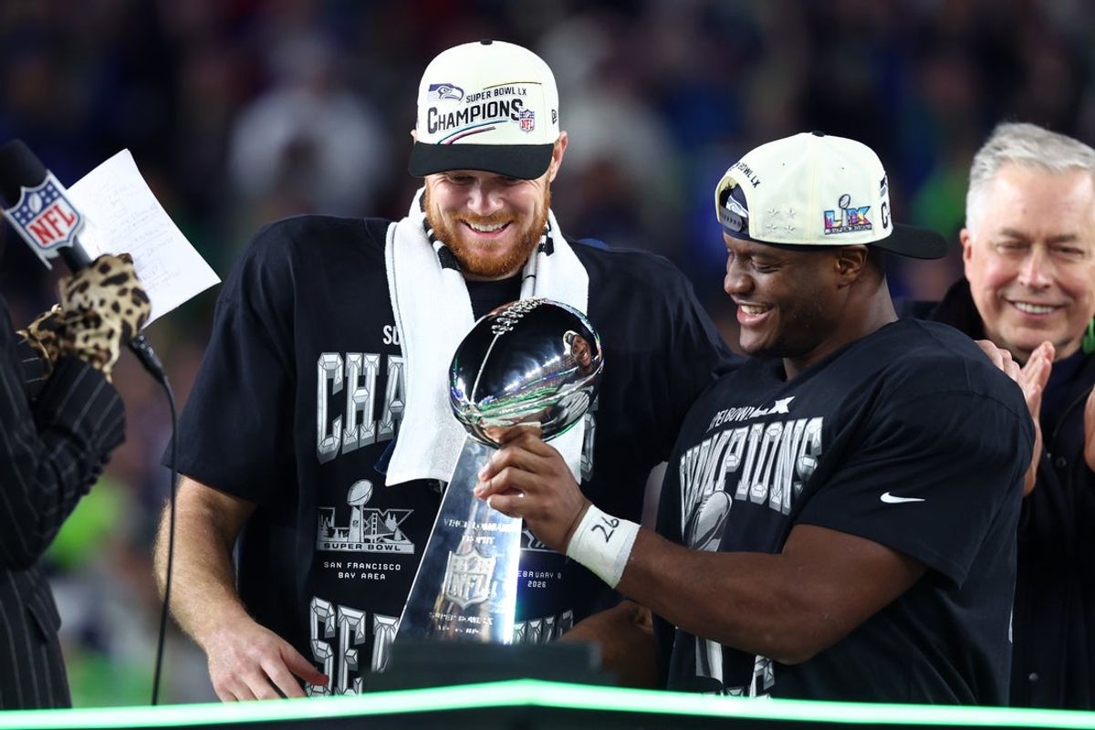 Feb 8, 2026; Santa Clara, CA, USA; Seattle Seahawks quarterback Sam Darnold (14) and running back Kenneth Walker III (9) celebrate with the Vince Lombardi trophy after defeating the New England Patriots in Super Bowl LX at Levi's Stadium. Mandatory Credit: Mark J. Rebilas-Imagn Images